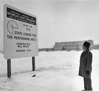 Man standing in front of construction sign