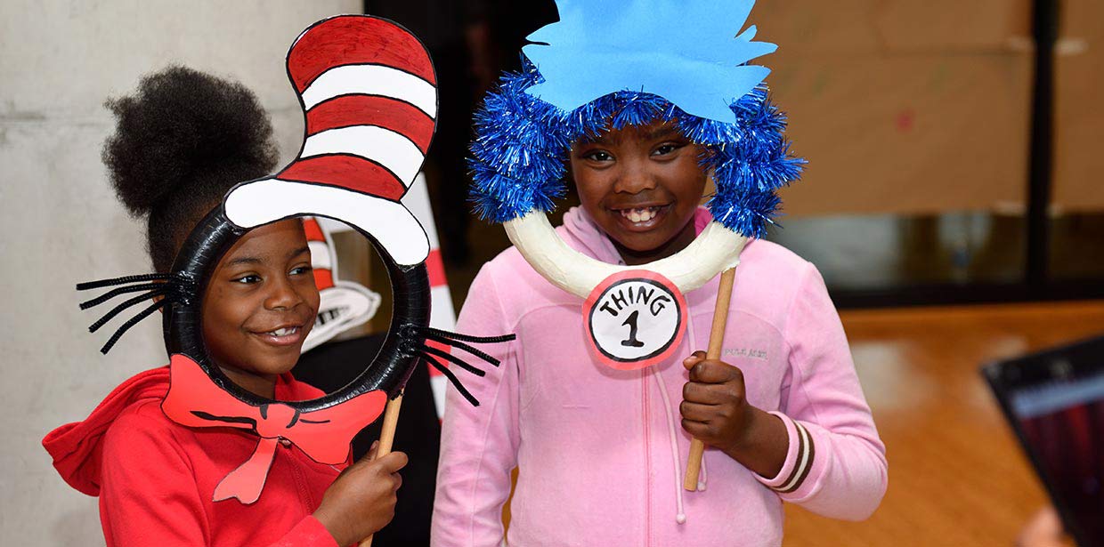 Sensory-Friendly Performances, two children hold Dr. Seuss crafts made before the performance